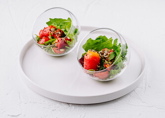 Fresh salmon spinach salad in glass bowls