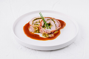 Gourmet stuffed pork roulade with savory sauce