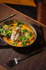 Spicy asian curry dish with herbs and cream
