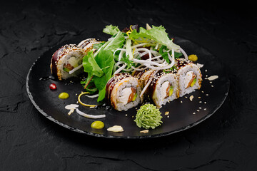 Exquisite sushi roll platter on dark slate