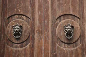 Symmetrical European style old wooden door knocker