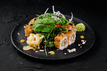 Gourmet sushi roll on elegant black plate