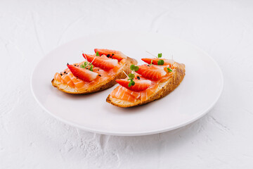 Gourmet smoked salmon toasts on white plate