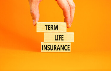 Term life insurance symbol. Concept words Term life insurance on beautiful wooden blocks. Beautiful orange table orange background. Doctor hand. Medical term life insurance concept. Copy space.