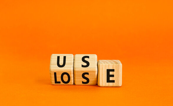You use or lose it symbol. Concept word Use or lose on wooden cubes. Beautiful orange table orange background. Business and you use or lose it concept. Copy space.