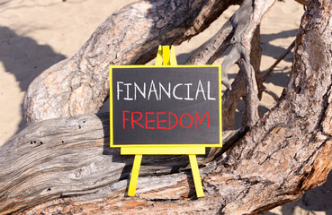 Financial freedom symbol. Concept words Financial freedom on beautiful black yellow blackboard. Beautiful tree background. Business financial freedom concept. Copy space.