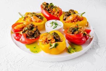 Colorful stuffed bell peppers on white plate