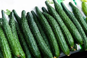 Fotobehang Pile of fresh cucumbers in market © xy