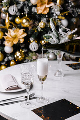 Elegant champagne toast by christmas tree