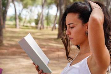 profile of a relaxed and concentrated woman reading a book