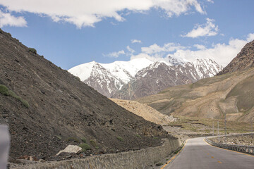 A Road toward Khyber Pass with snow-covered mountains