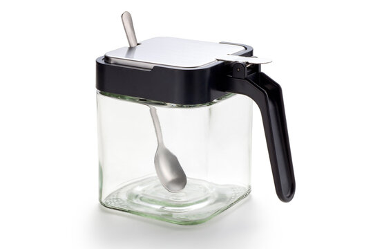 Empty glass condiment jar with spoon on white background, Food containers for salt, pepper or sugar