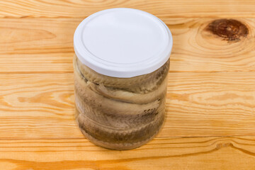 Pickled herring fillets in sealed jar on rustic table - 787046106
