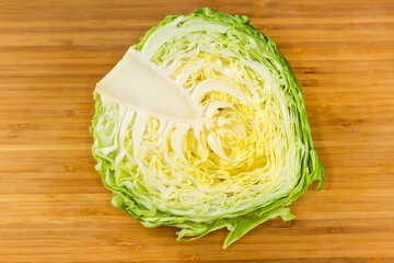 Top view of half of white cabbage on cutting board