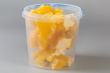 Crystallized honey in open plastic container on a gray background - 787046174
