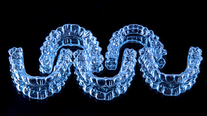Invisible aligners teeth retainers lie on the mirror