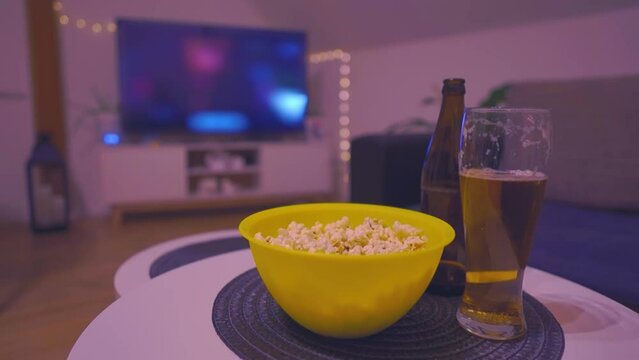 Enjoying watching favorite TV shows with beer and popcorn