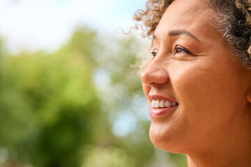 Close Up Portrait Of Smiling Senior Woman Outdoors In Countryside Or Garden