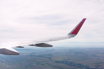 Panoramic view of plane wing with Earth below