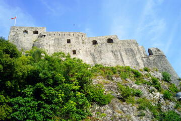 Bottom view of the ancient Montenegrin fortress Forte Mare, built on a cliff above the Adriatic Sea
