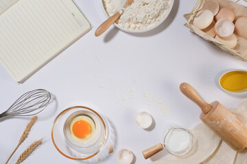 Blank space in the middle of picture with some baking ingredients and utensils surrounded, scene...