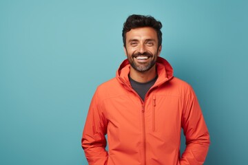 Obraz premium Portrait of a glad man in his 30s wearing a windproof softshell isolated on pastel teal background