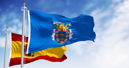 Melilla and national spanish flag flag waving on a clear day - obrazy, fototapety, plakaty