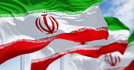 Islamic Republic of Iran national flags waving on a clear day