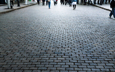 People walking on stone brick road