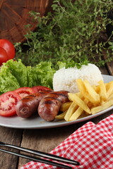 sausage, french fries and salad