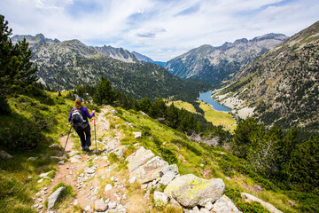 Fototapeta na wymiar Young hiker woman in Vall de Boi, Aiguestortes and Sant Maurici National Park, Spain