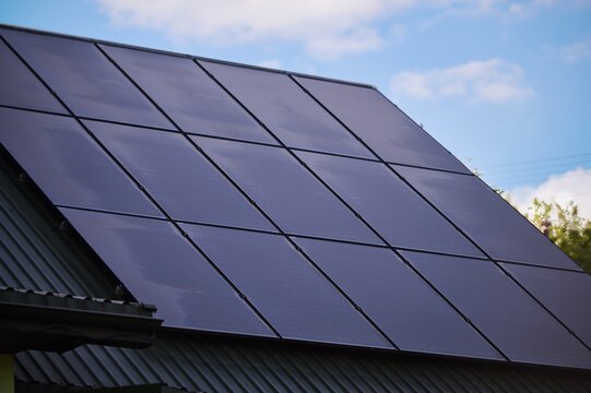 Set of photovoltaic lady on the roof of the house; blue sky