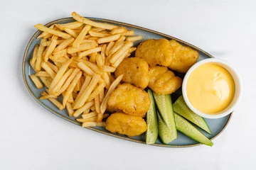 Gordijnen french fries with nuggts and cheese sauce © Maksim Shebeko