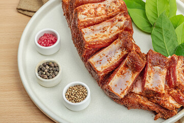 Marinated raw ribs with spices and herbs. Traditional ingredient for BBQ, picnic concept