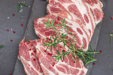 Raw pork neck meat. Chop steak, red peppercorn, garlic cloves, sea salt and fresh rosemary