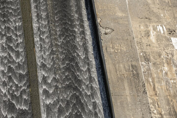A dam is built with materials such as stone or concrete, sometimes taking advantage of a closed or...