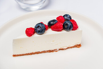 cheesecake with berries on the white