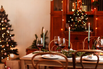Candles and wine on Christmas table