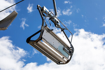 ski lifts against the background of a blue sky with clouds. Ski resort Active recreation