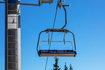 close-up of ski lifts against the background of a blue sky with clouds. Ski resort Active recreation