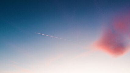 Airplane trail in the blue sky
