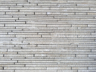 Natural decorative stone wall gray tones for use as background.