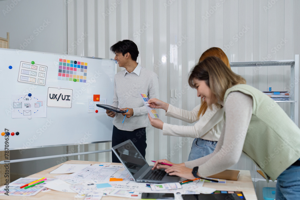 Wall mural ui designers present to team about color design of logo during application design brainstorming. cre