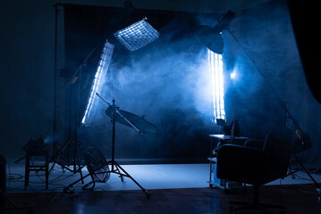 photo studio, dark background, smoke, photo studio equipment