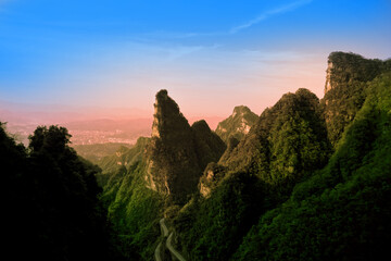 Fototapeta na wymiar Quartzite sandstone pillars and green tree peaks and mountain scenery, Zhangjii National Park, Hunan Province.