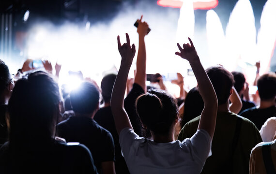 People hands making rock gesture at the concert