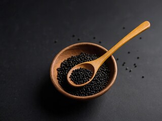 Mustard seeds (black) on a black background.