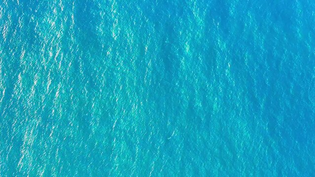 Atlantic ocean texture. Turquoise sea water background. Calm blue sea waves cover the landscape. Flowing clean water in motion. Close up of blue water surface in deep sea.