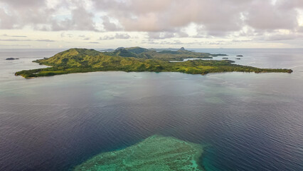 Drone view of the Fiji Islands. Ocean waters. Clouds over the islands. Vacation and travel concept.