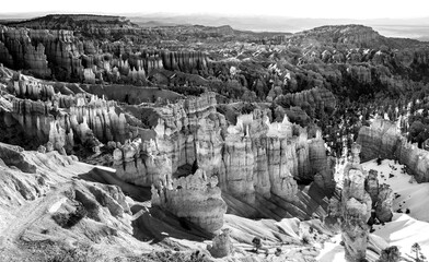Bryce Canyon wide angle panorama in contrasting black and white. National park with hundreds of unique “hoodoos“ formed by erosion. Popular tourist attraction and natural reserve seen from view point.